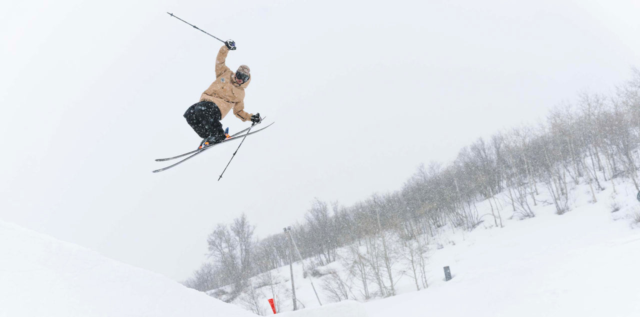 Skier goes off jump wearing baggy ski jacket
