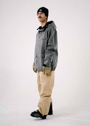 Cool skier wearing men's gray ski jacket and khaki bib ski pants