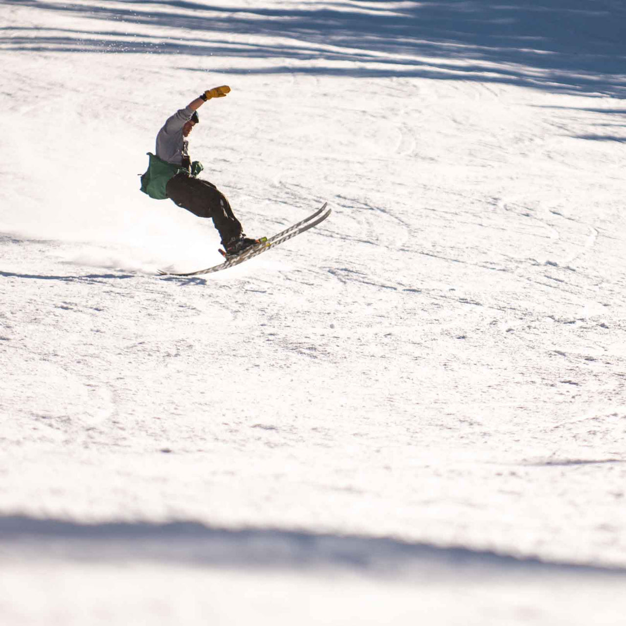 skier tail butters wearing a baggy ski bib pant