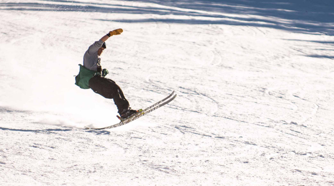 skier doing trick while wearing baggy ski bib pant
