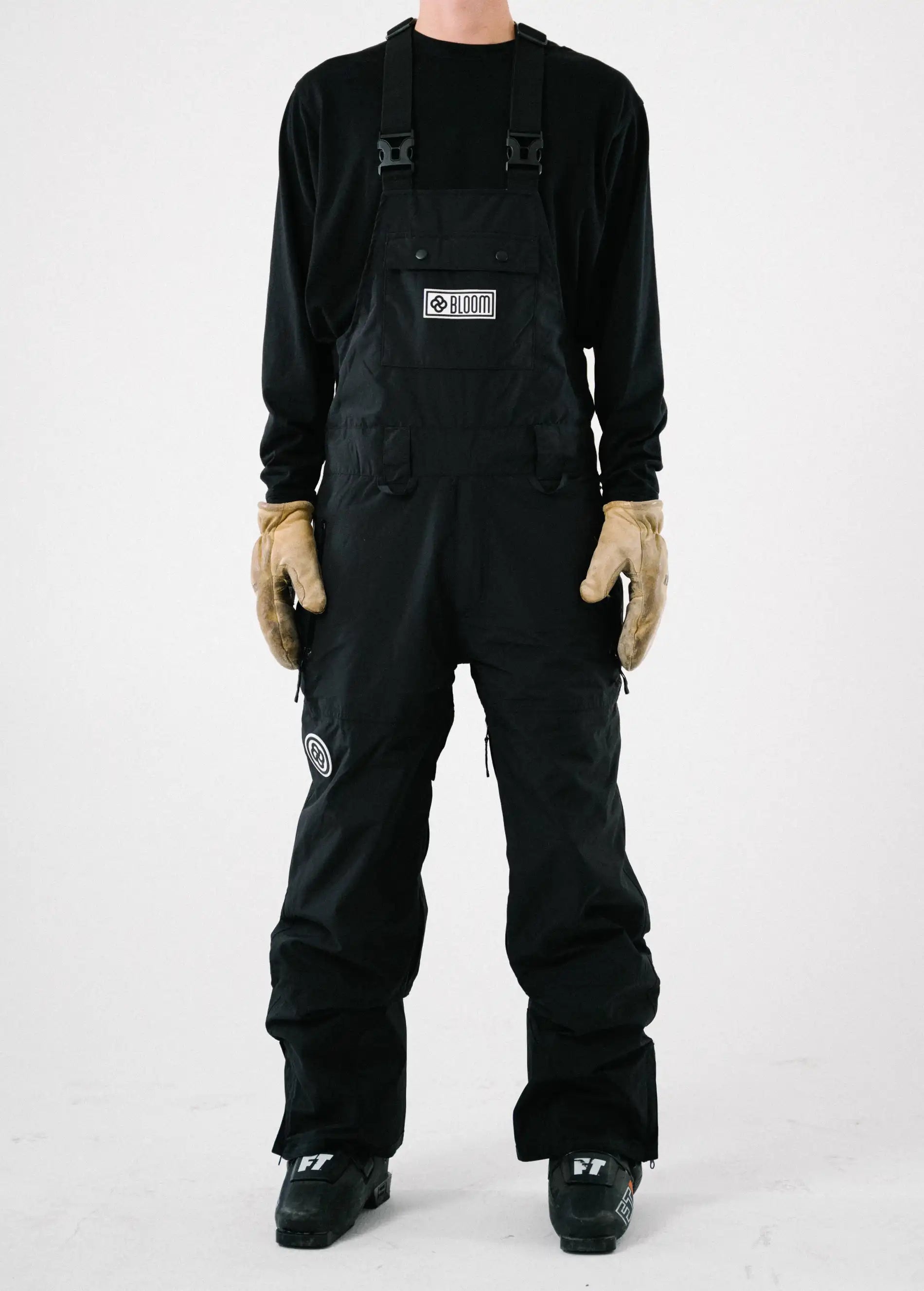 Mens black ski bib shell pant against white backdrop