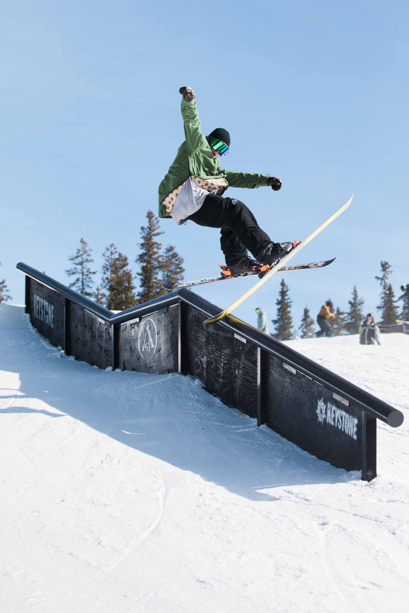 Man slides rail in park wearing the best baggy snowboard pants