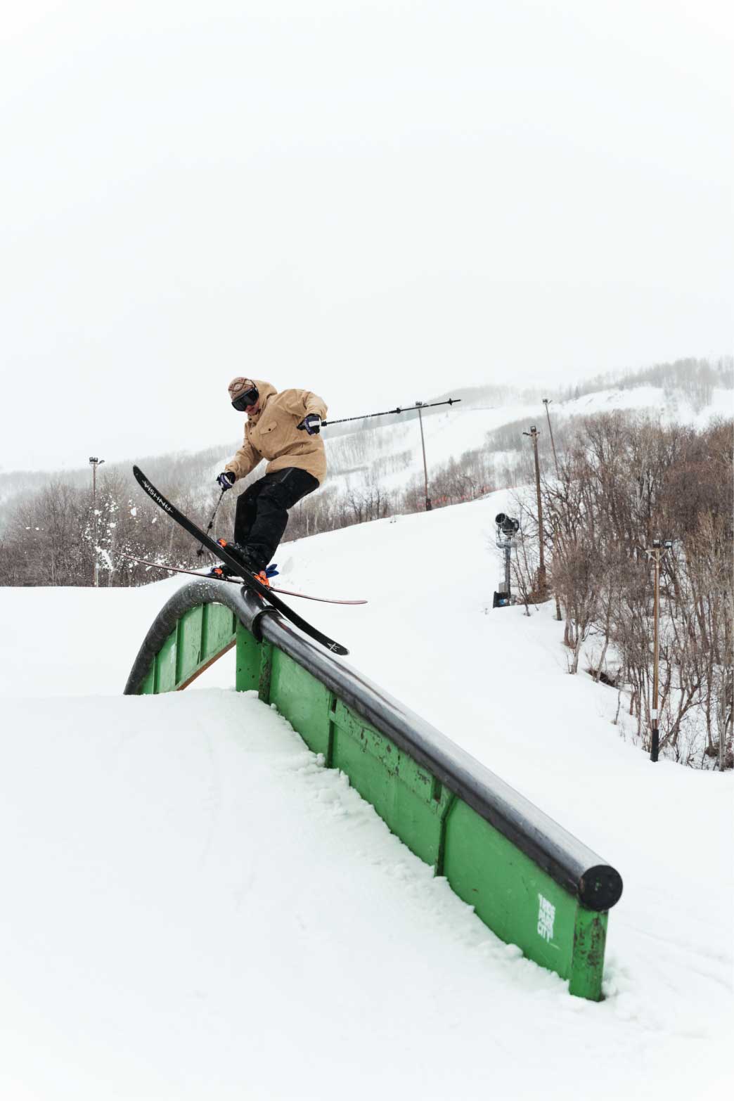 Skier slides rail wearing the best ski jacket for park