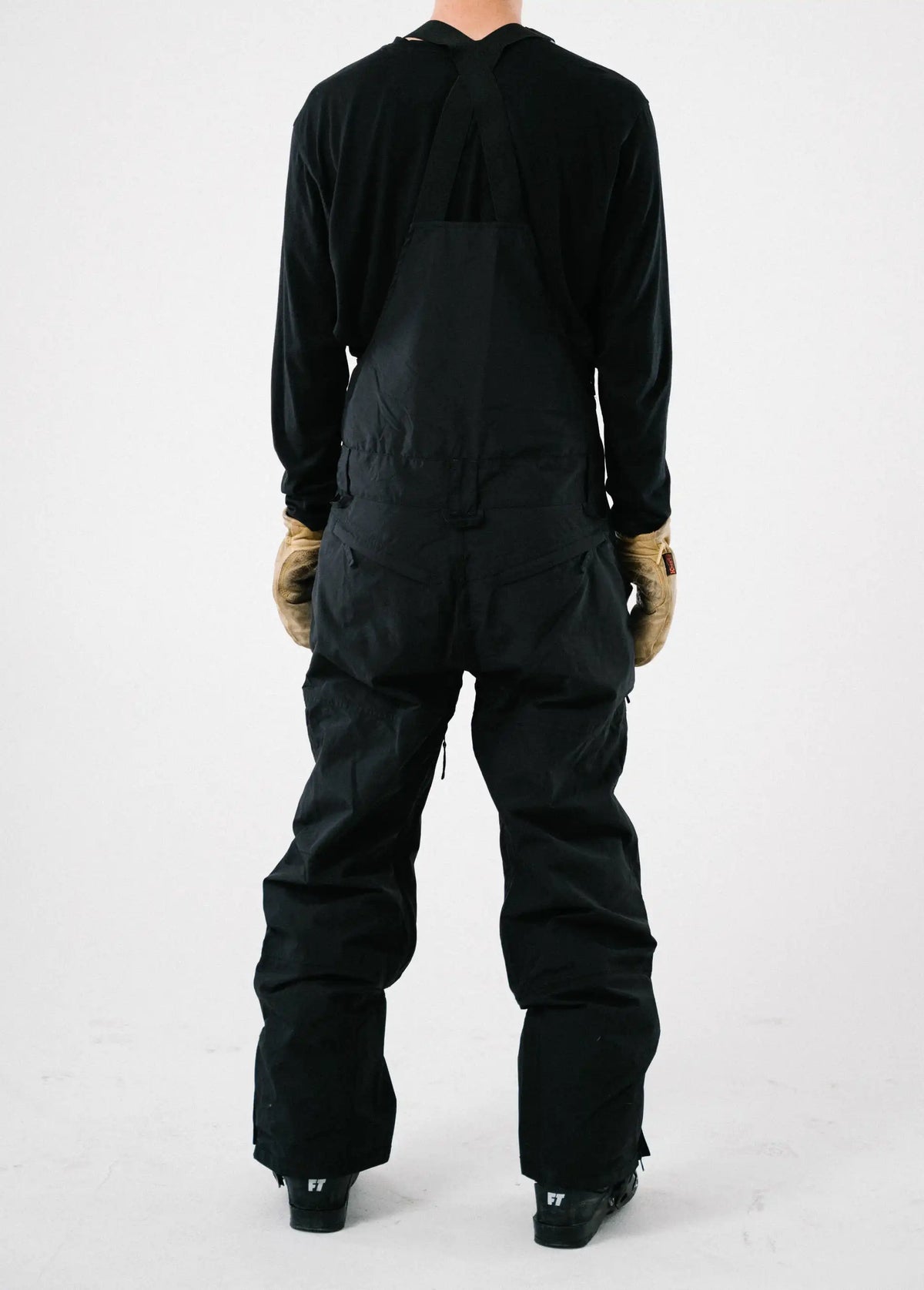 Back studio view of a men's black ski bib