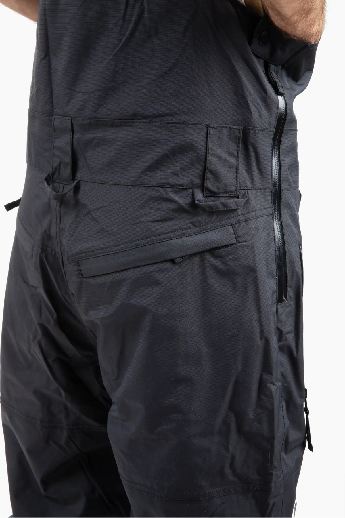Close up of black ski bib shell with belt loop and D rings