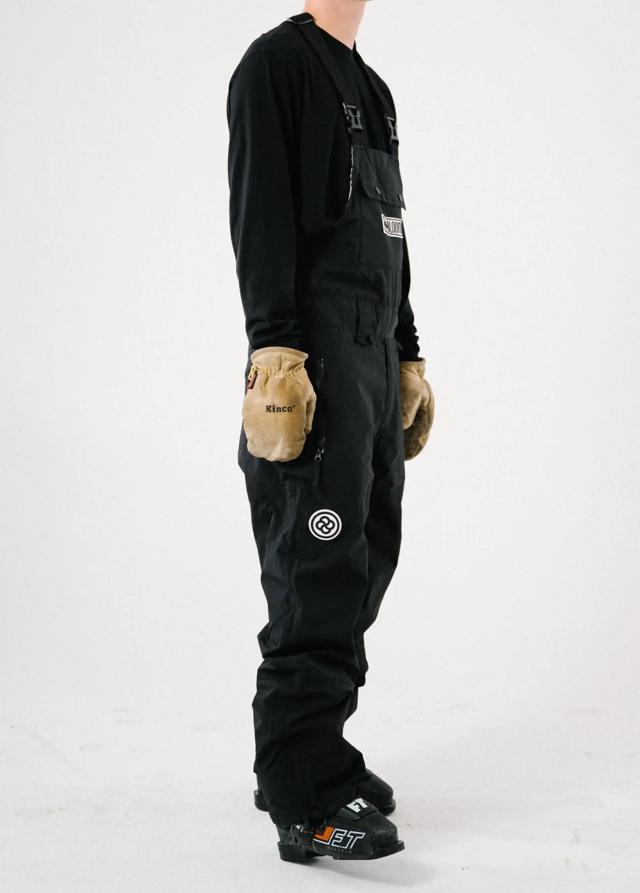 Side view of a men's black ski bib shell