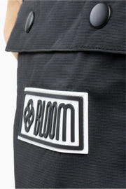 Close up of black ski bib shell with silicone branding