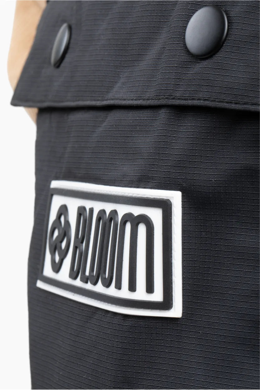 Close up of black ski bib shell with silicone branding