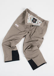 Brown baggy snowboard shell pants laid flat