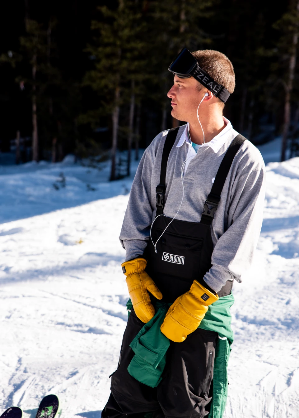 Skier wearing cool black baggy snow pants against forest backdrop