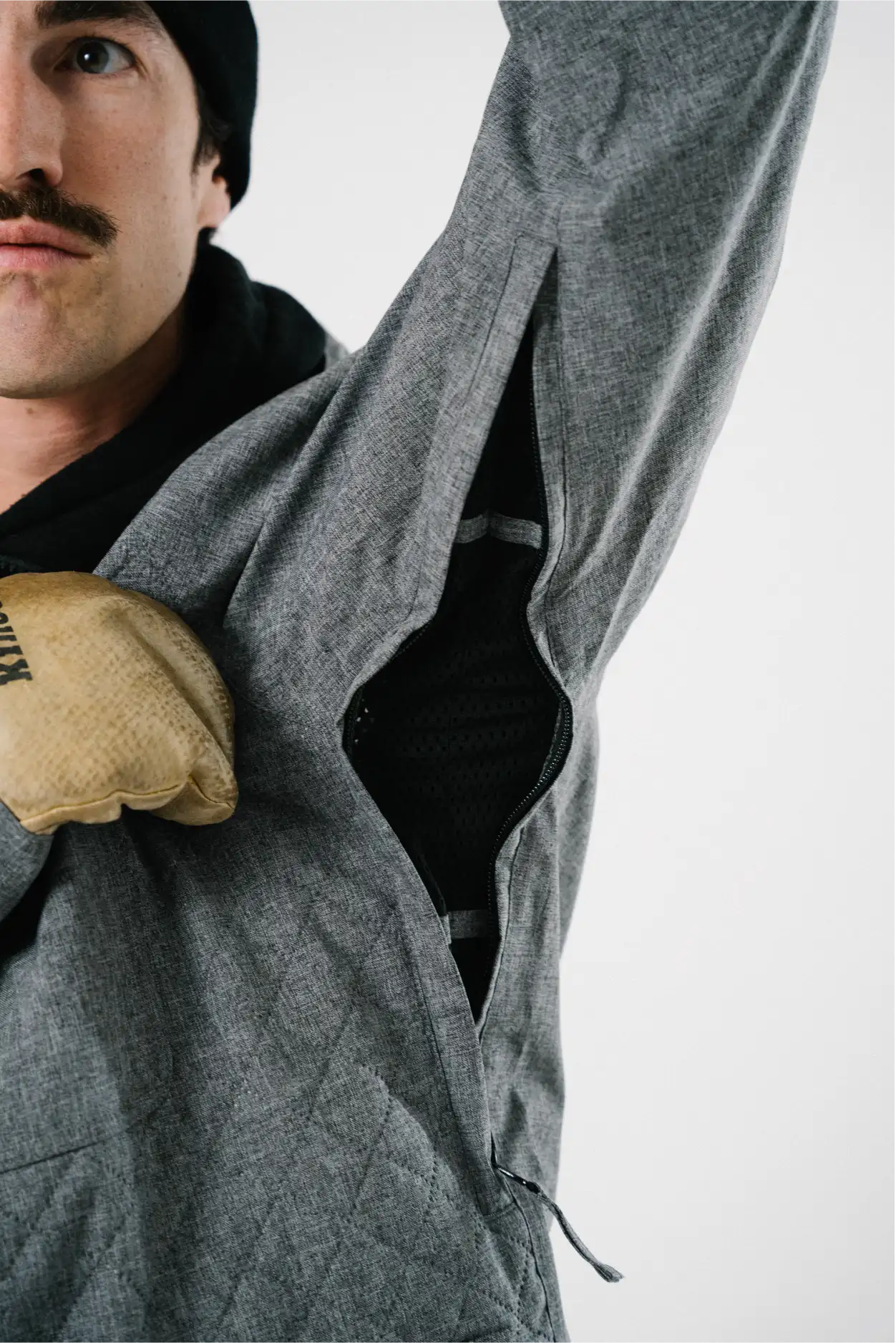 Men wearing gray quilted ski jacket with vents
