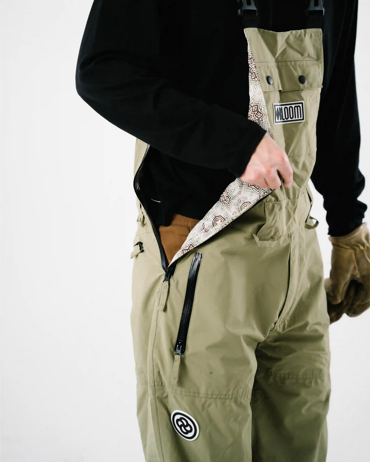 Close up of men's green ski bib shell side zipper