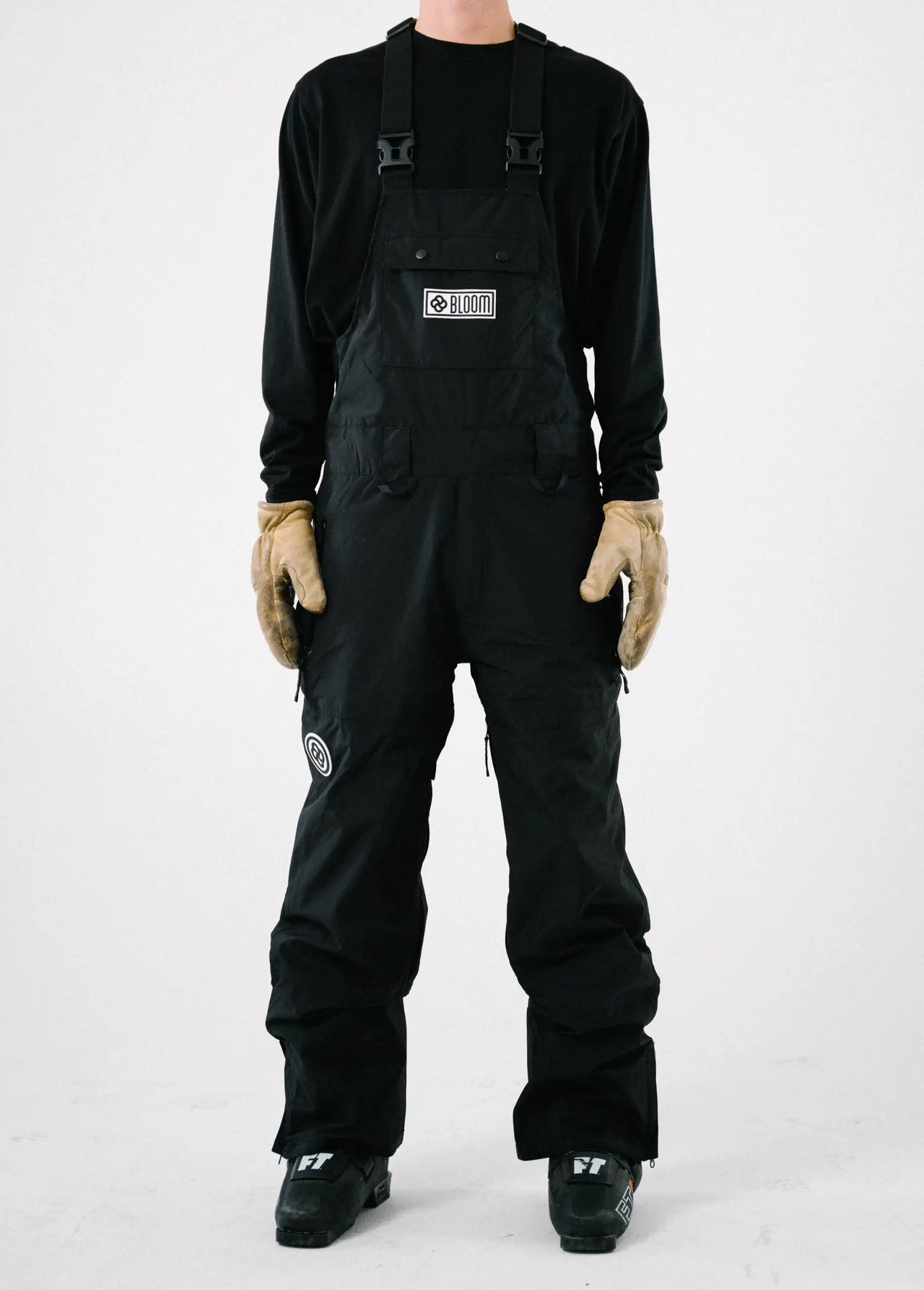 A view of a mens black ski bib shell pant from the front with white background