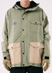 Photo of the front of an insulated green ski jacket  with quilted pattern against a white backdrop