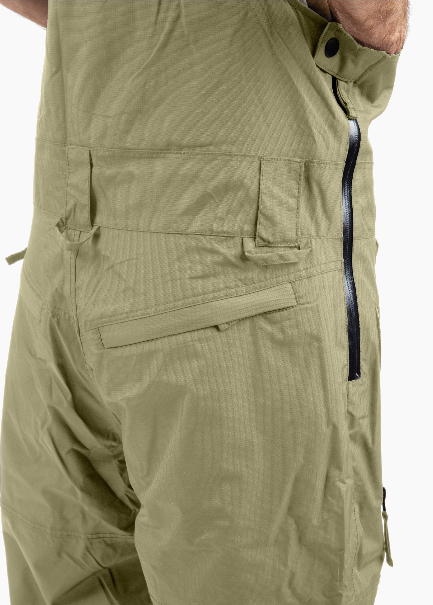 Men’s green Bloom Rove snowboard bib showing the side-entry zipper, belt loops, and rear pockets.
