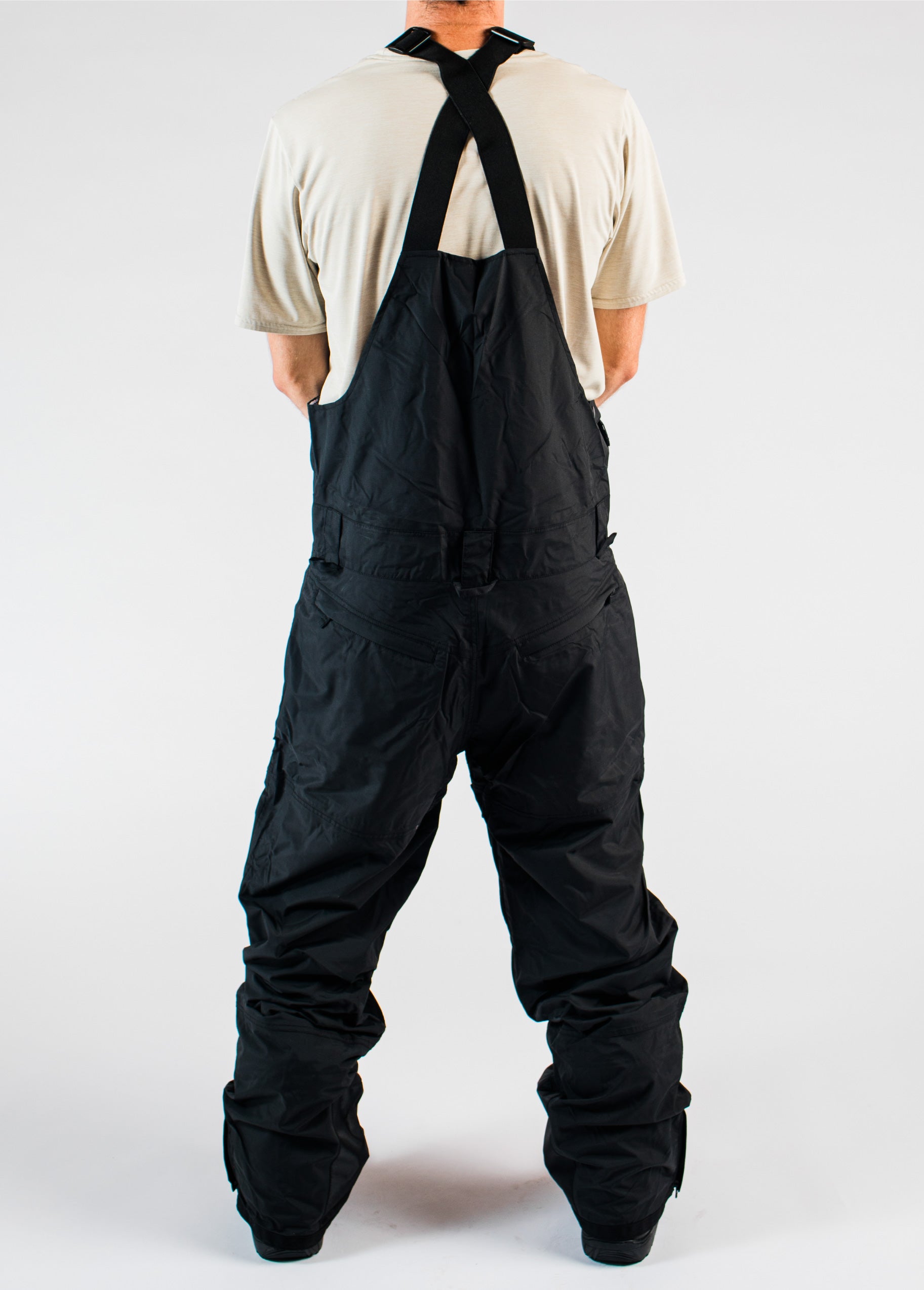 Back view of men's black snowboard bib