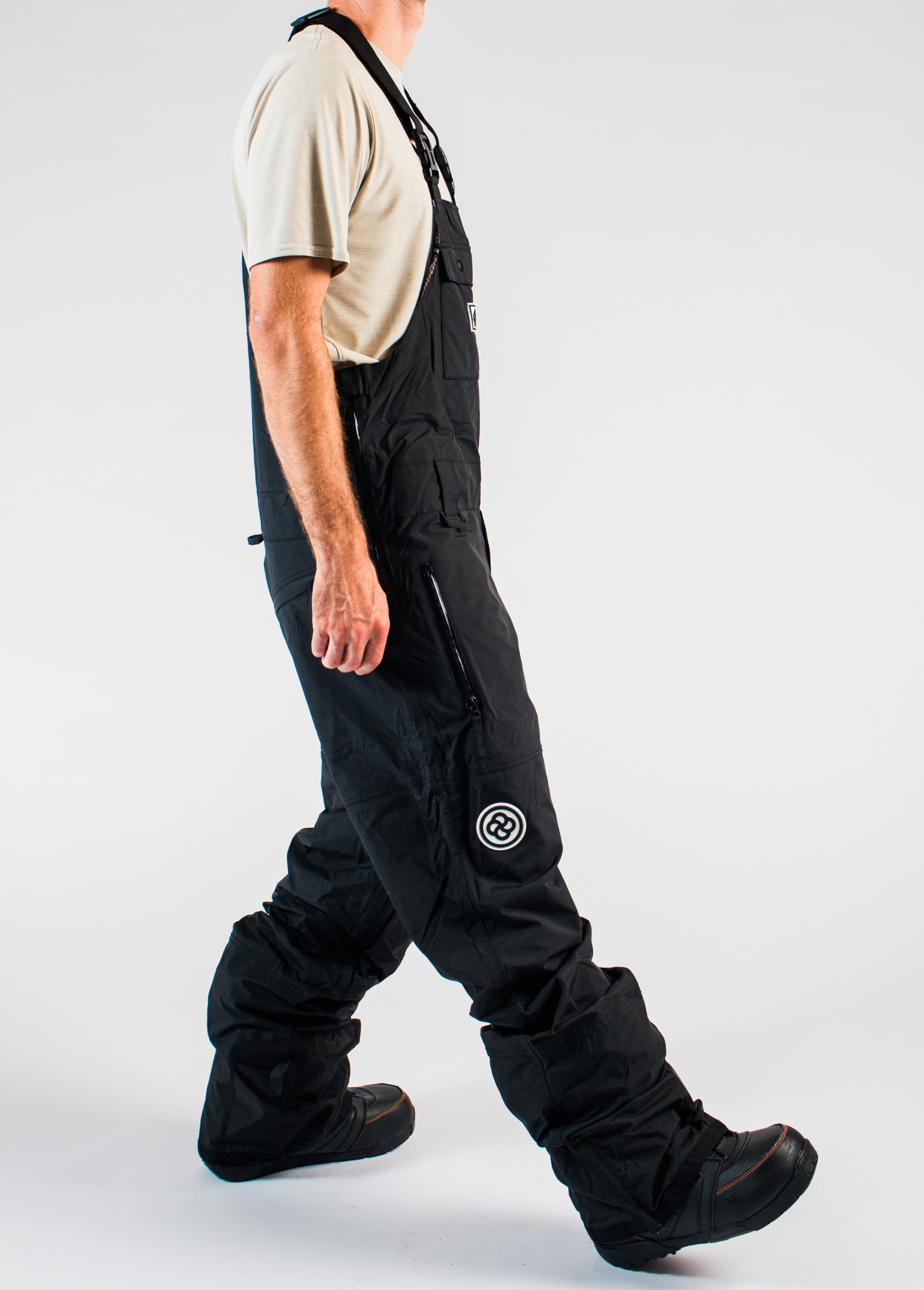 Side view of men's black snowboard bib