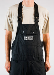 Men's black snowboard bib with release buckles and adjustable suspenders