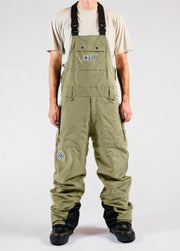 Men’s green shell snowboard bib pants with a baggy fit and adjustable suspenders.
