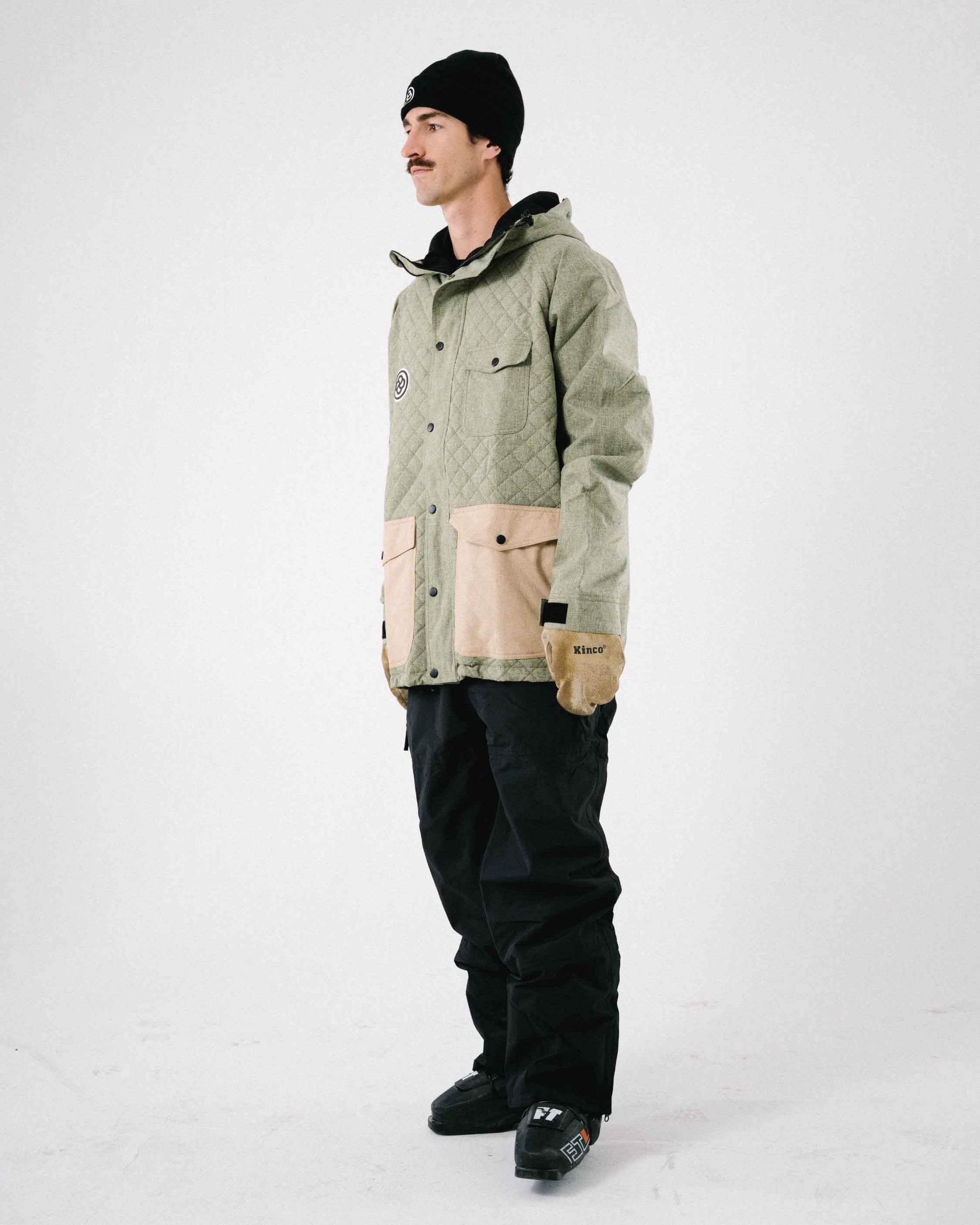 Man wearing a cool snowboard fit against white backdrop