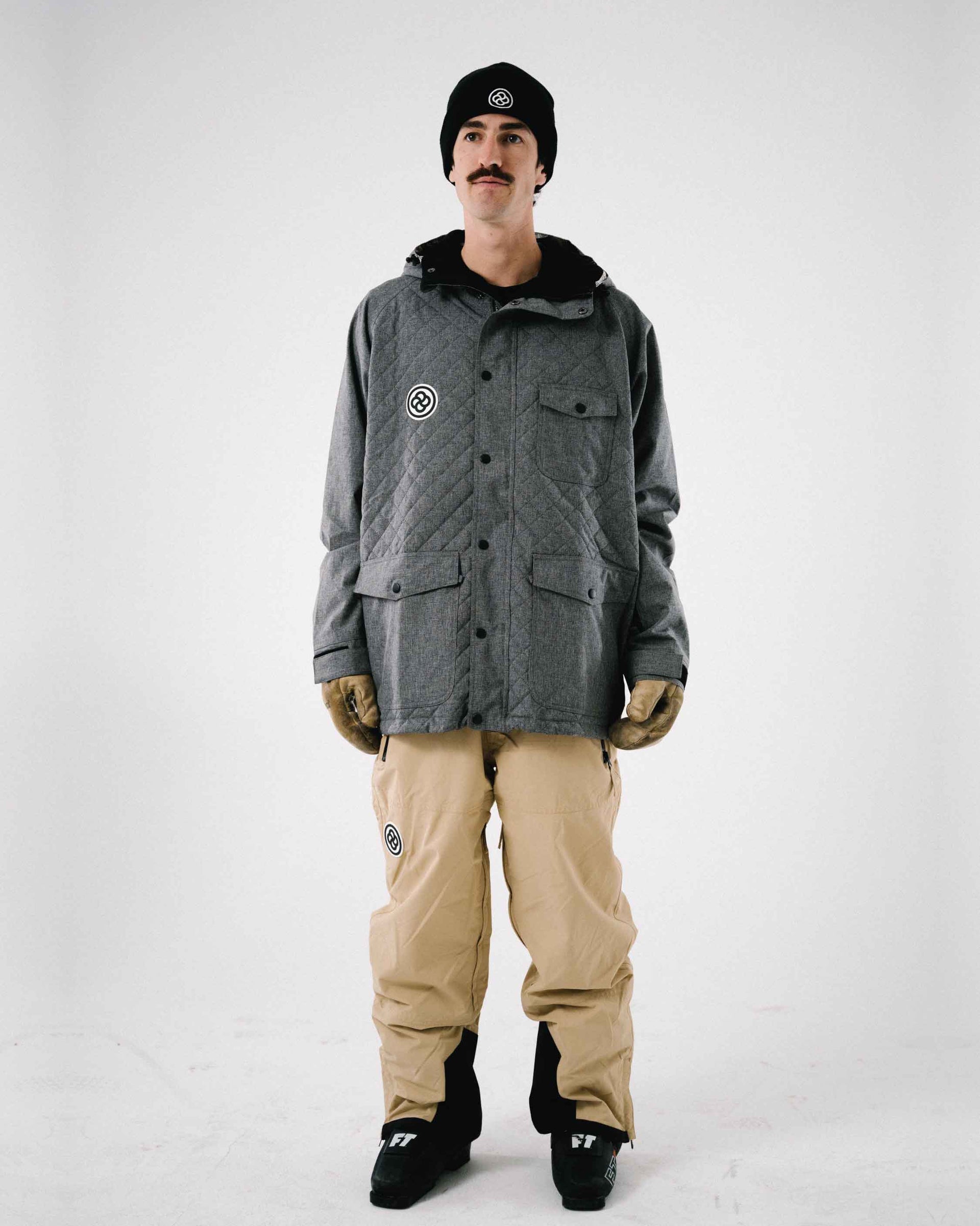 Man wearing a cool snowboard kit against white backdrop