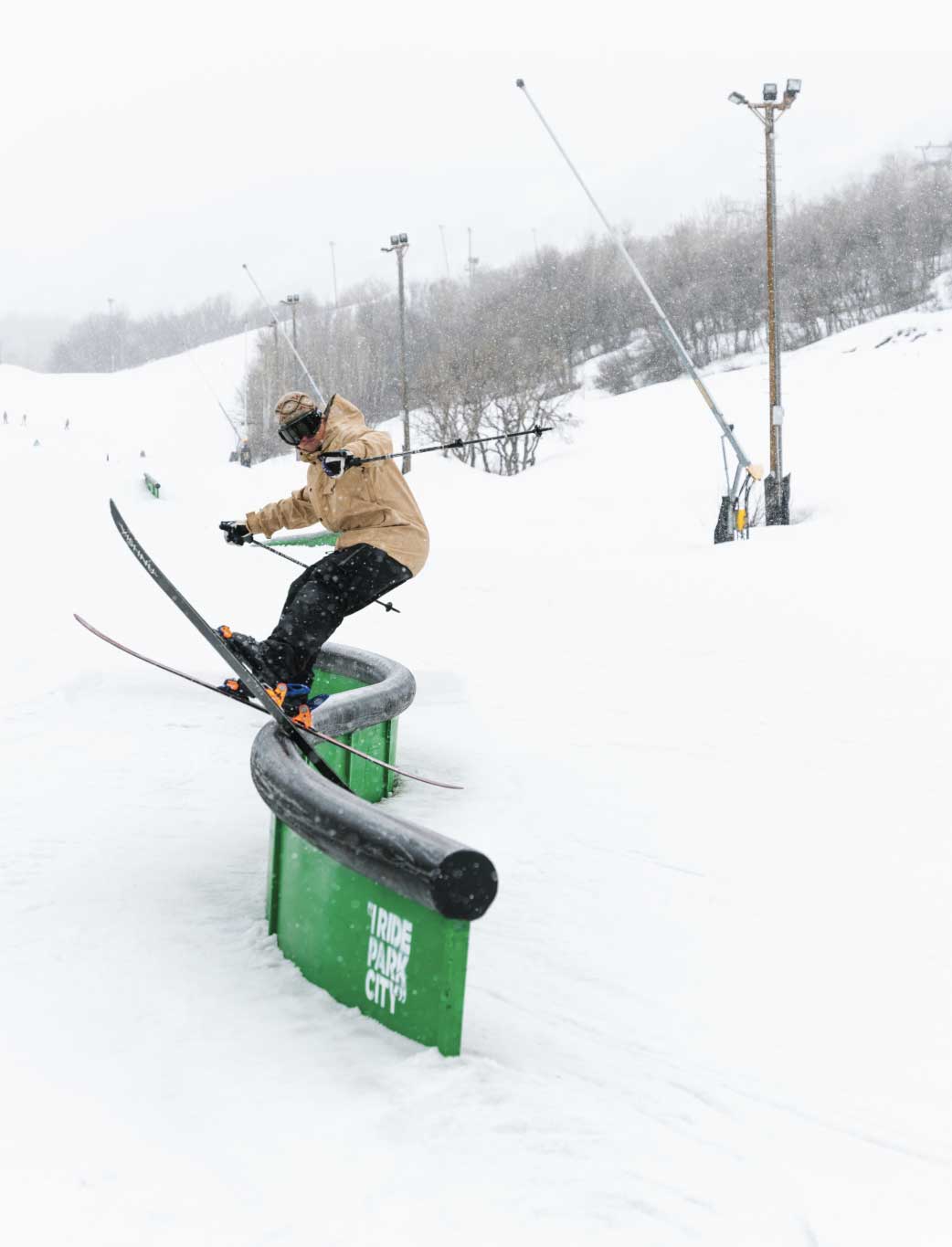 Skier slides rail wearing a park ski outfit by Bloom Outerwear