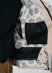 Tan ski jacket with powder skirt and google pockets