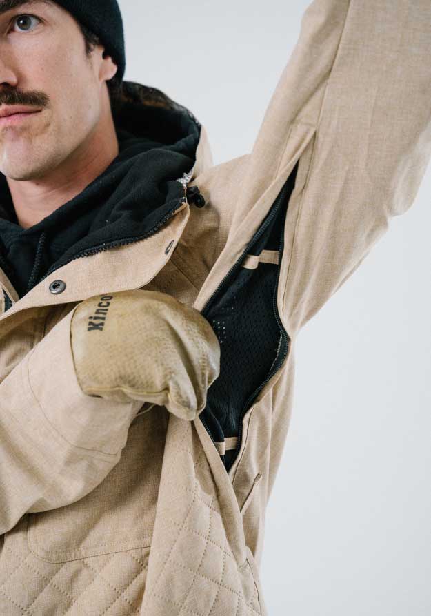 Tan ski jacket with underarm vents that have a mesh liner